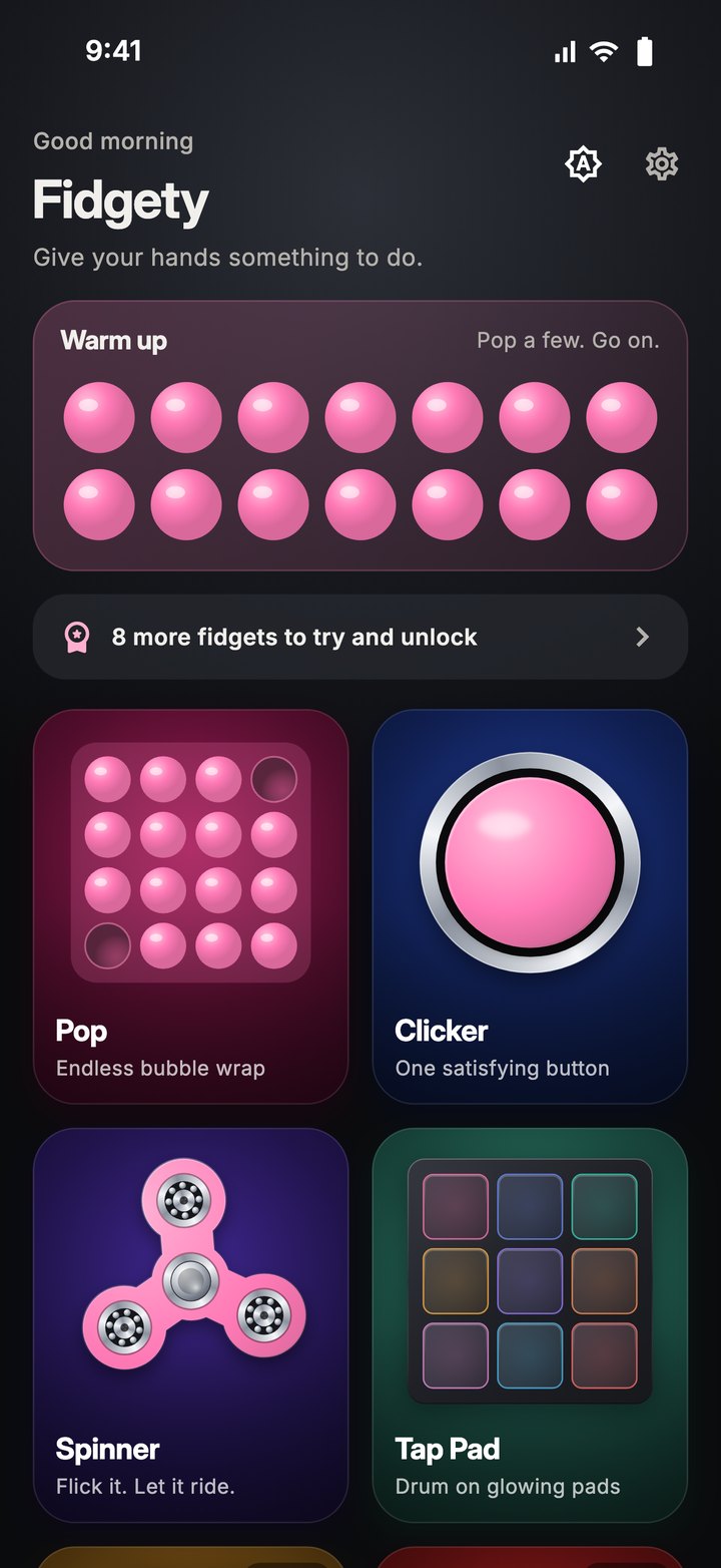 Fidgety's home screen: a strip of bubble wrap to pop, above tiles that each show one of the toys on its own lit backdrop